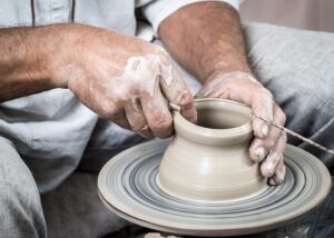 A person crafting a pot